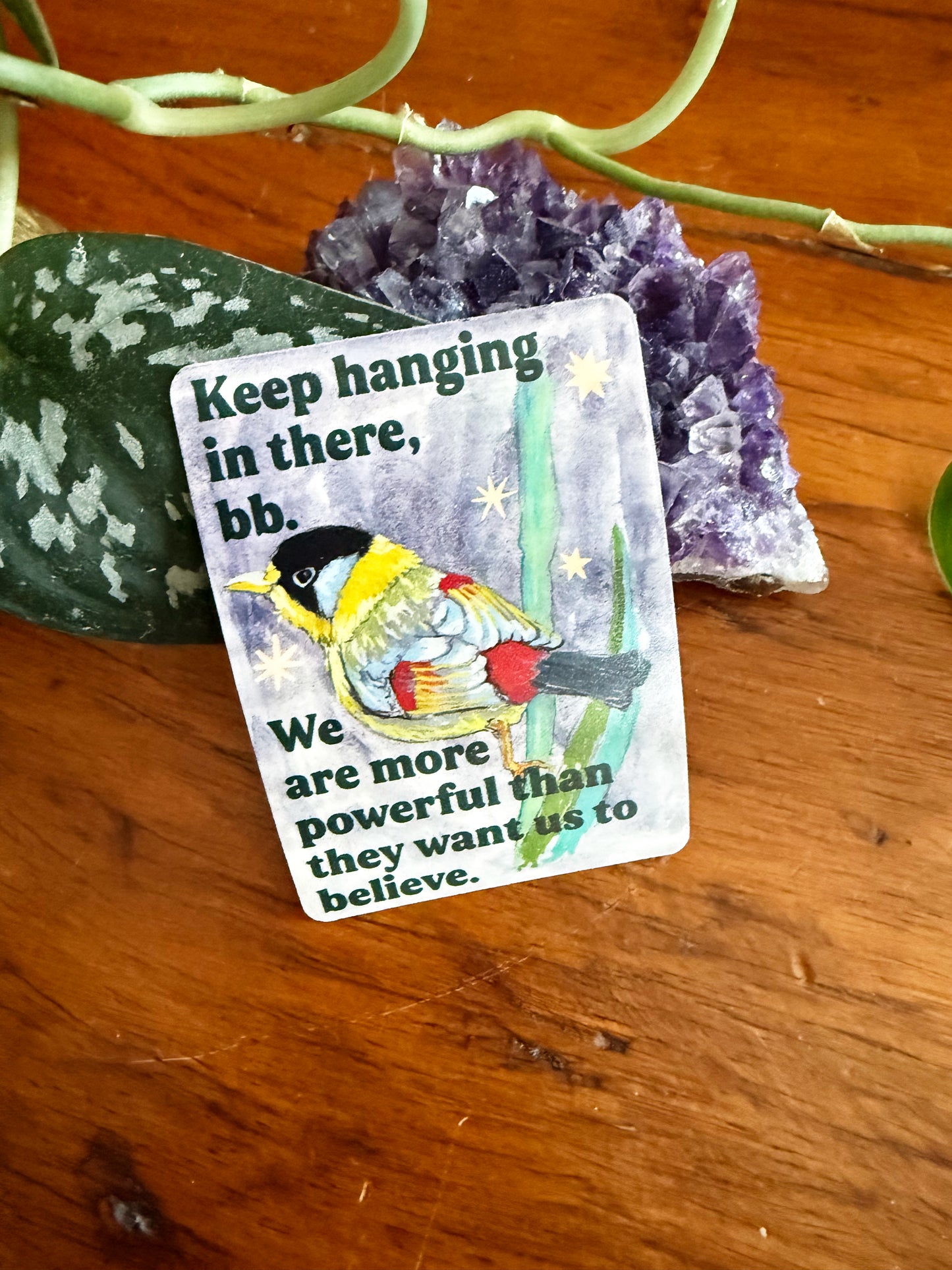 Keep hanging in there, bb. We are more powerful than they want us to believe: feminist sticker