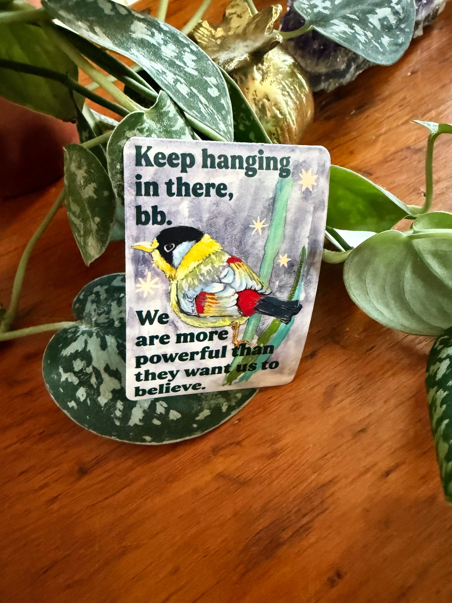 Keep hanging in there, bb. We are more powerful than they want us to believe: feminist sticker