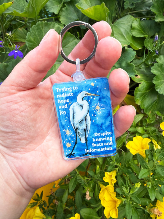 Trying to radiate hope and joy despite knowing facts and information: feminist keychain