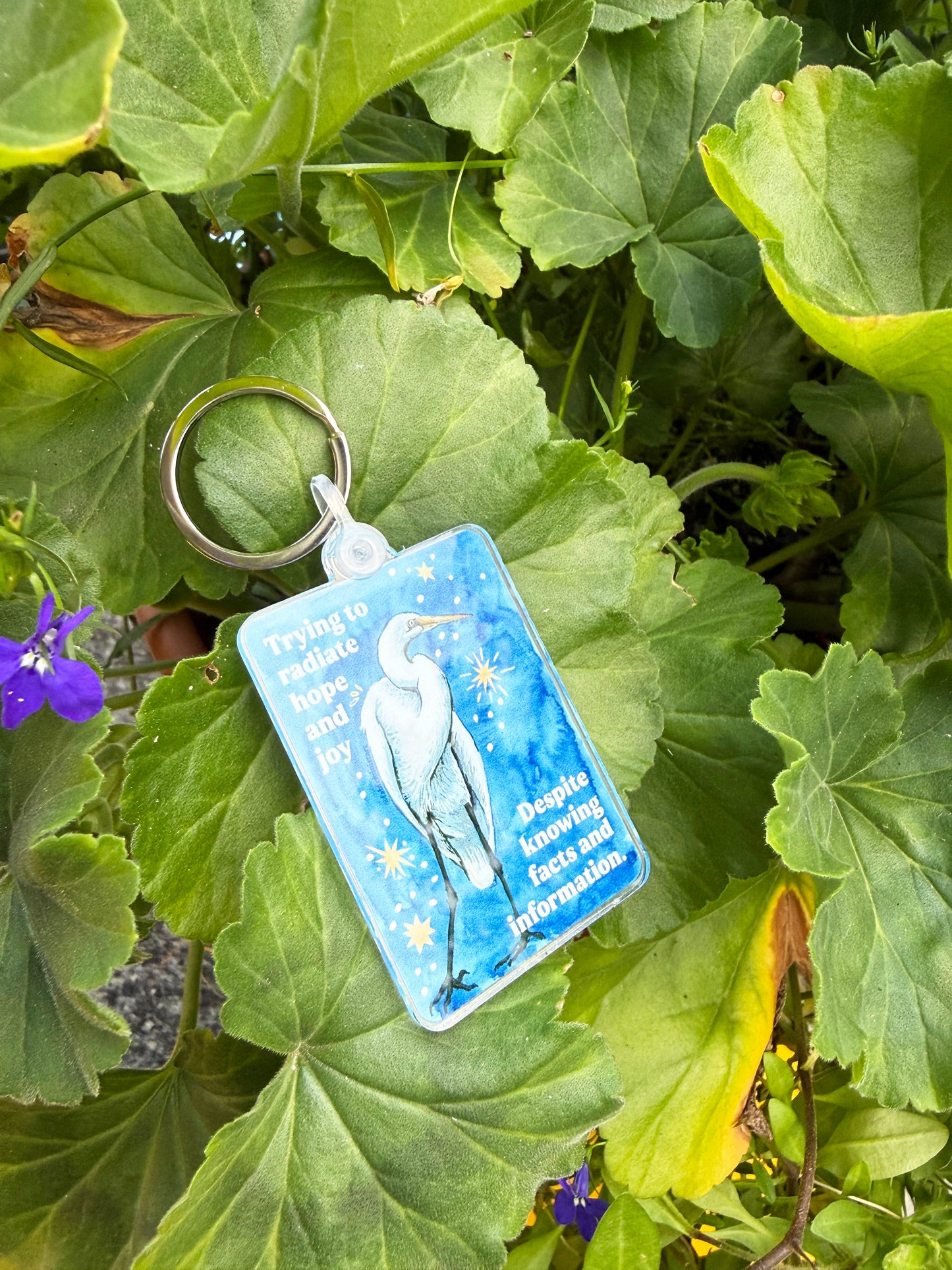 Trying to radiate hope and joy despite knowing facts and information: feminist keychain