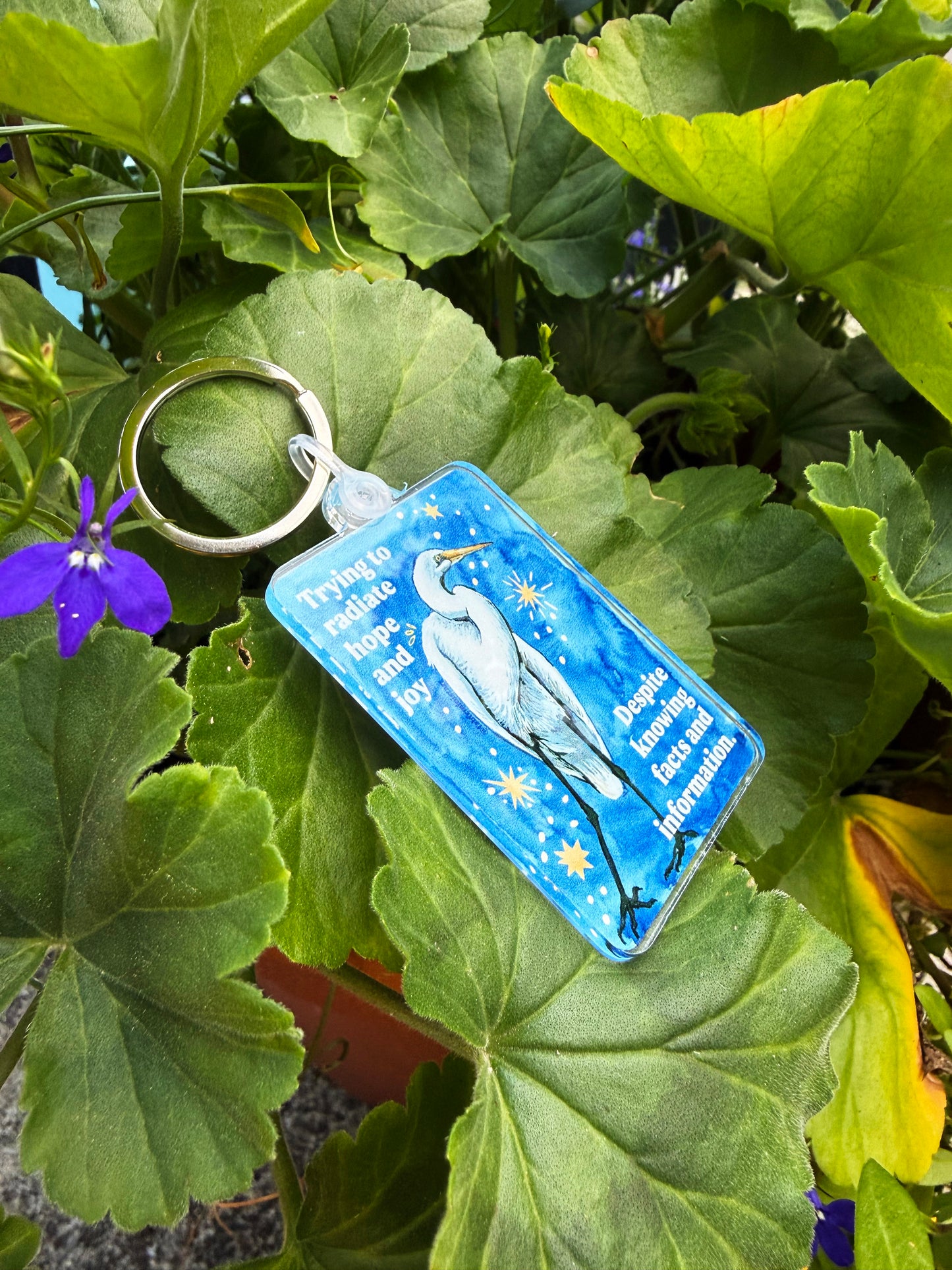Trying to radiate hope and joy despite knowing facts and information: feminist keychain