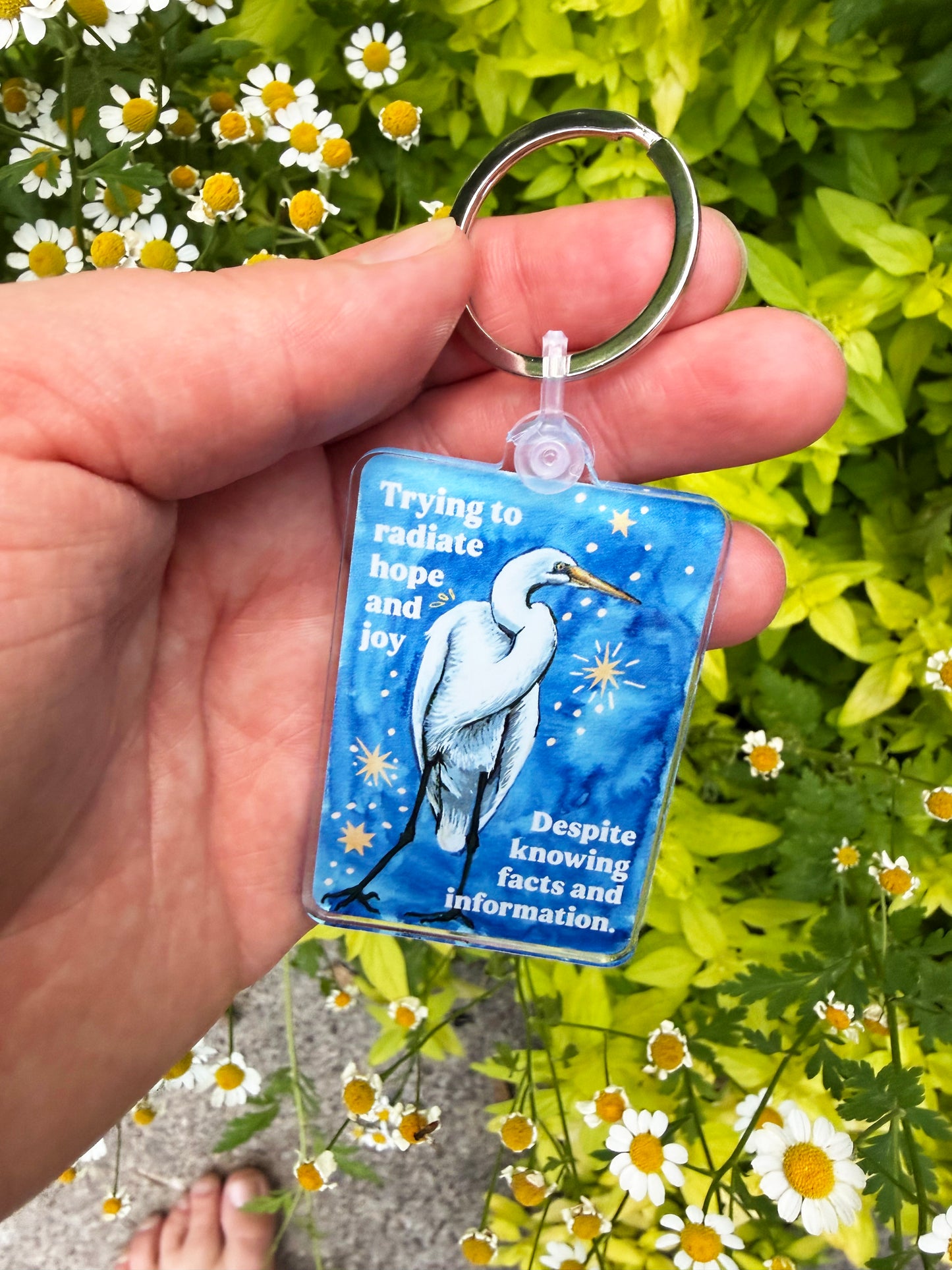 Trying to radiate hope and joy despite knowing facts and information: feminist keychain