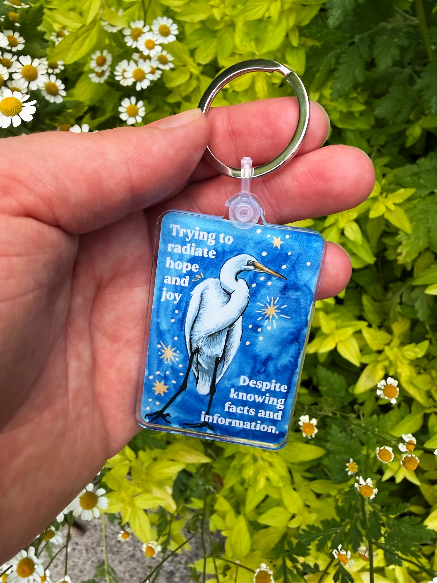 Trying to radiate hope and joy despite knowing facts and information: feminist keychain