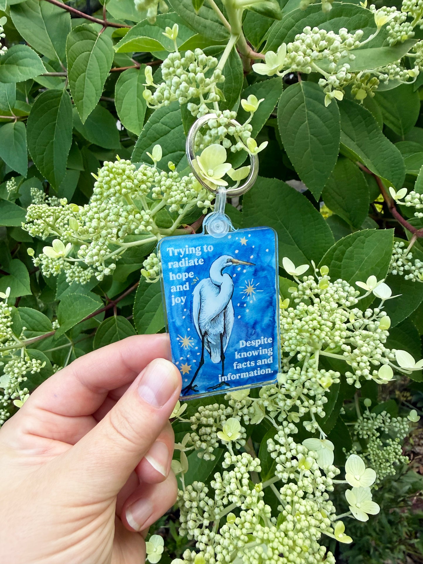 Trying to radiate hope and joy despite knowing facts and information: feminist keychain