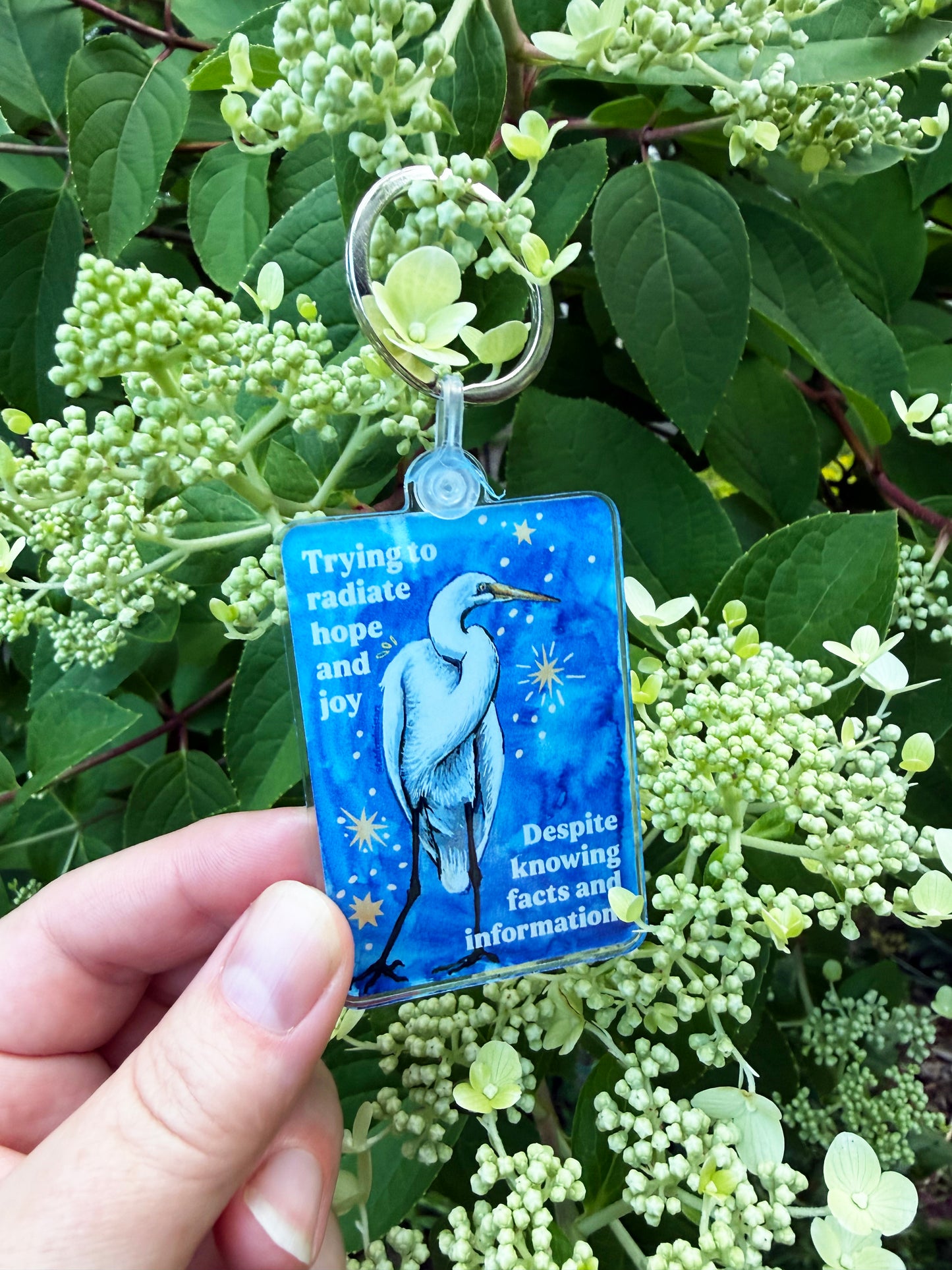 Trying to radiate hope and joy despite knowing facts and information: feminist keychain