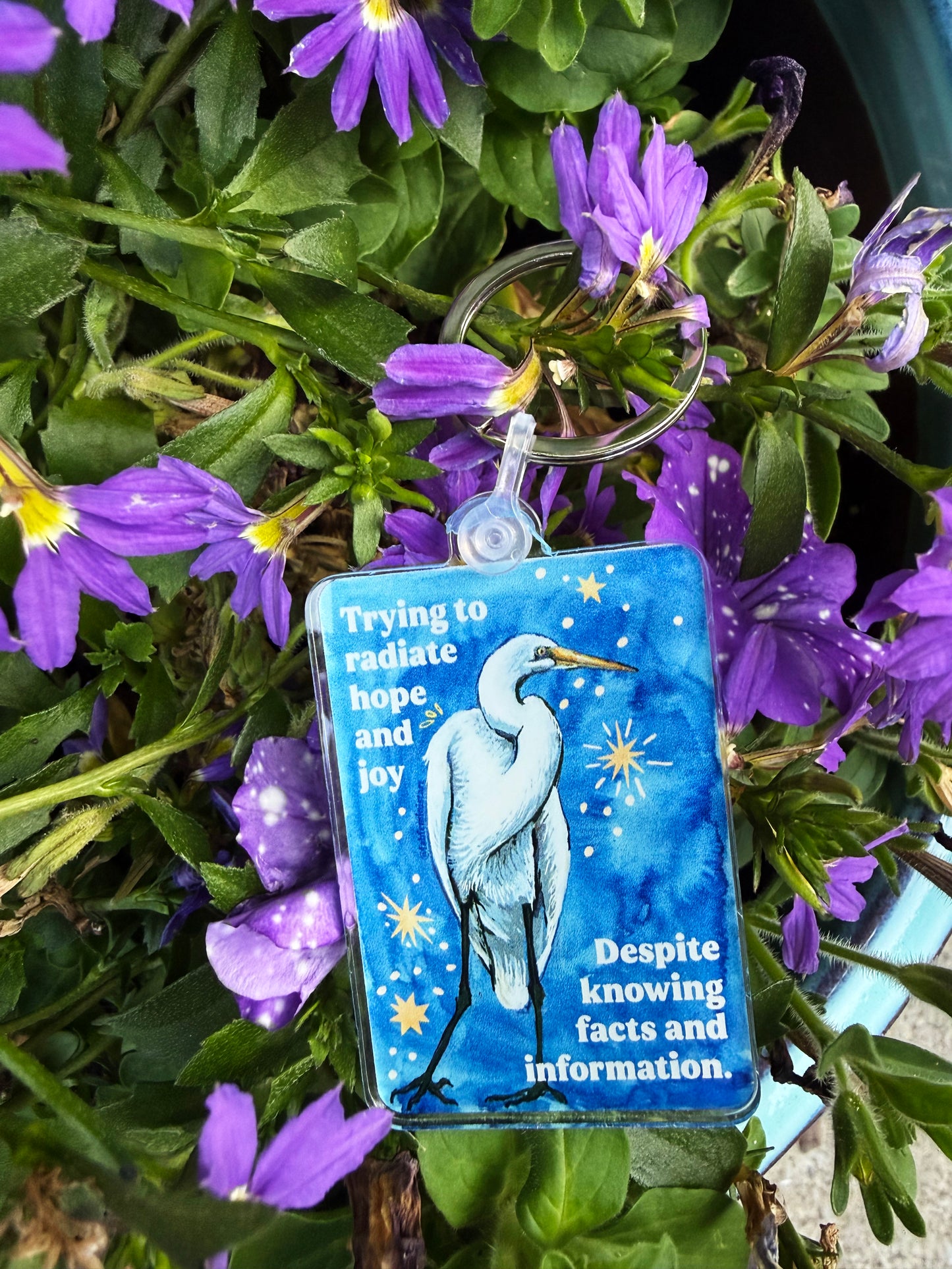 Trying to radiate hope and joy despite knowing facts and information: feminist keychain